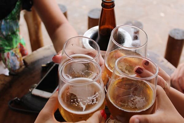 People enjoying beer in glasses