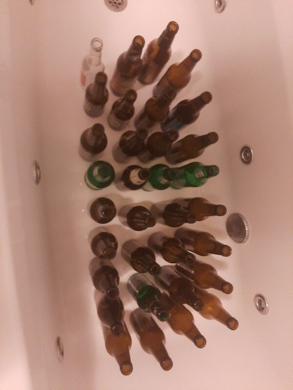 beer bottles ready for cleaning in a bath