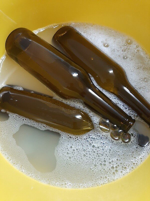 beer bottles in a sanitizer before bottling